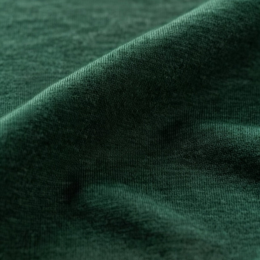 closeup of merino wool fabric. Jersey kniw, dark green