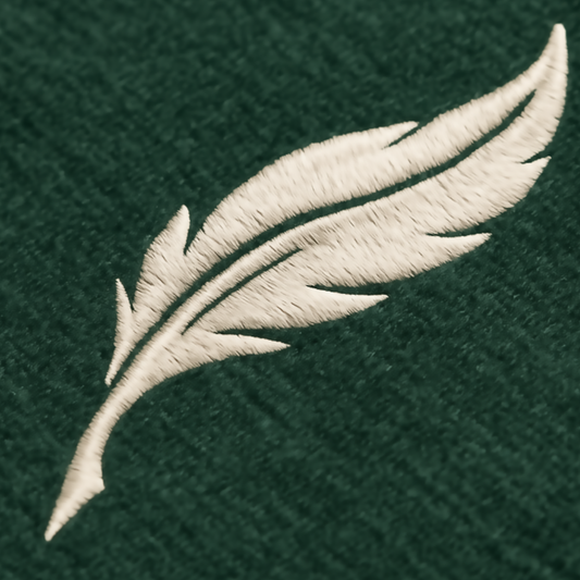 Feather logo for Audere. Gold embroidered feather on dark green background